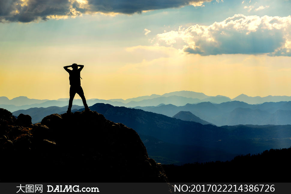 登顶后面朝群山的人物摄影高清图片