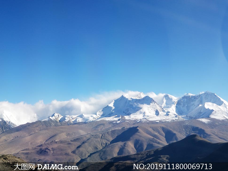 蓝天下的雪山山峦摄影图片