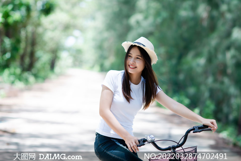 戴帽子骑自行车的美女摄影高清图片